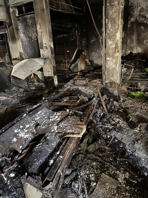 Mobilier de commerce brûlé et débris au sol après un incendie à Échirolles